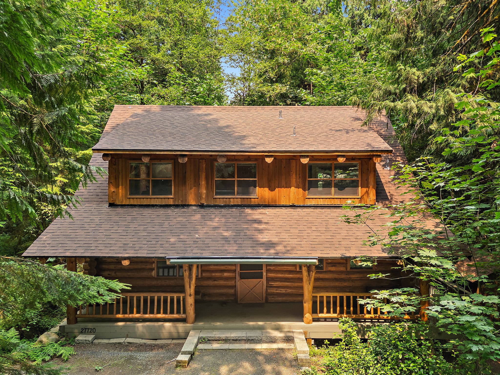Log cabin set back in the trees on a quiet dead-end road.
