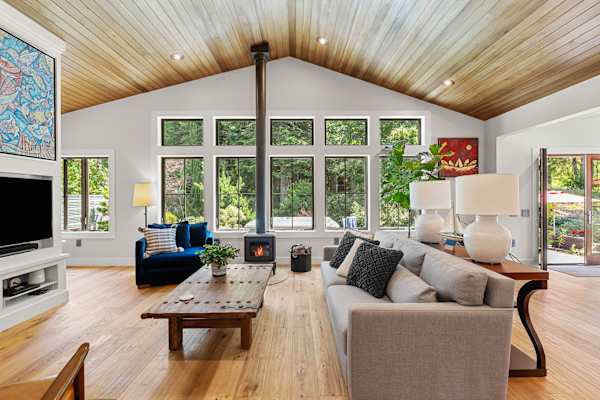 The great room: vaulted cedar ceilings and a wall of forest