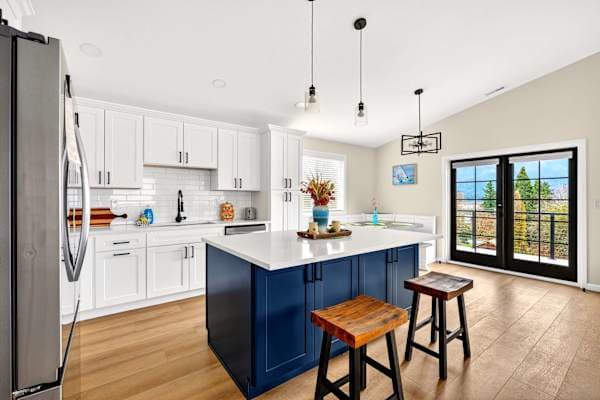 Full kitchen with island seating — cook with the view behind you