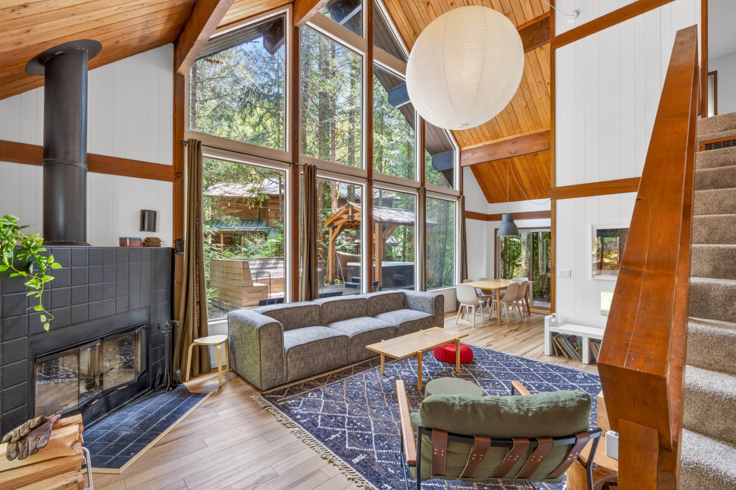 Living room with vaulted windows and fireplace.